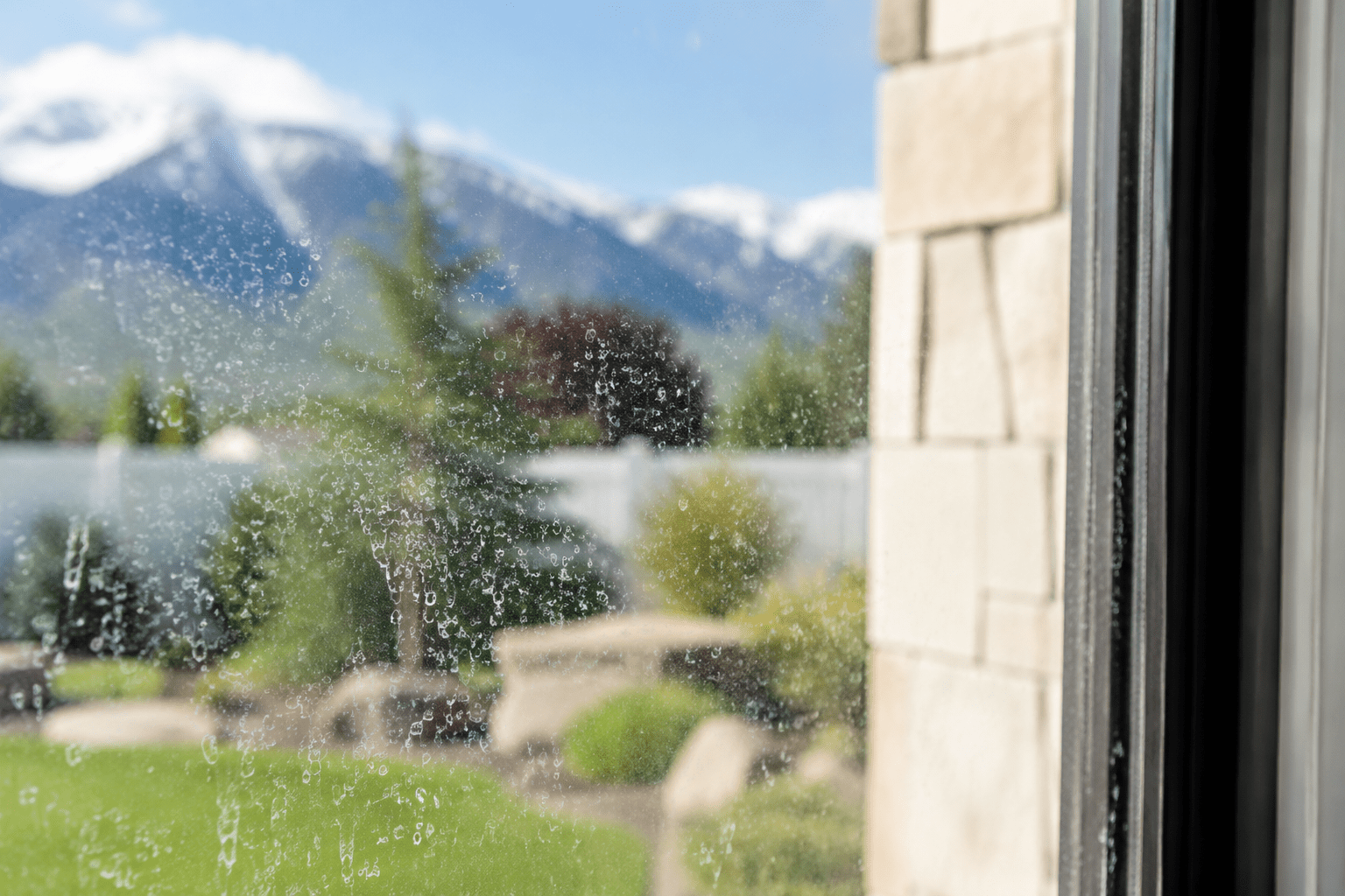 Hard-water mineral staining on a window in Utah