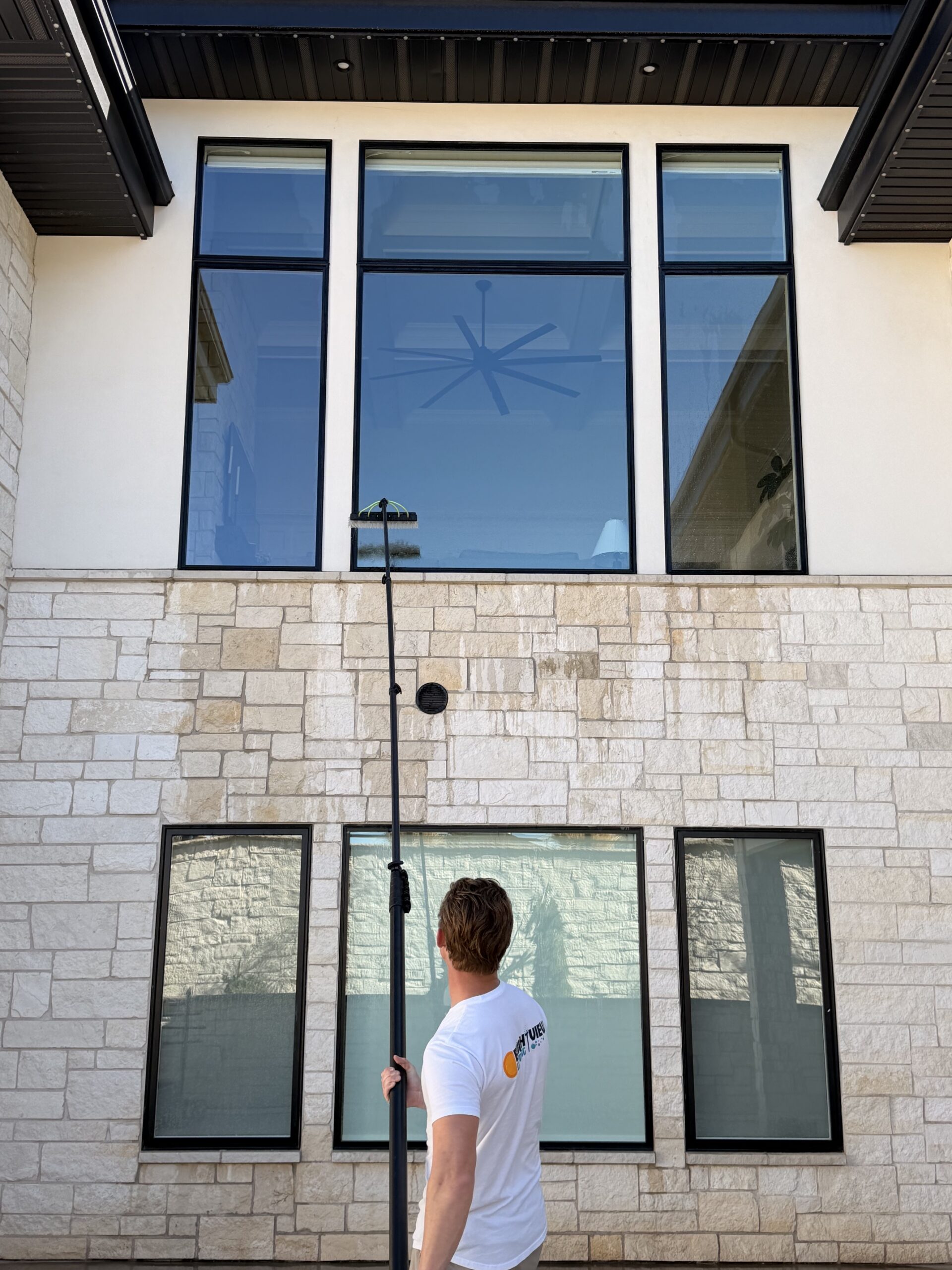 Water-fed pole system cleaning upper-level exterior windows
